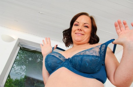 Overweight mom gets completely naked before masturbating with a sex toy
